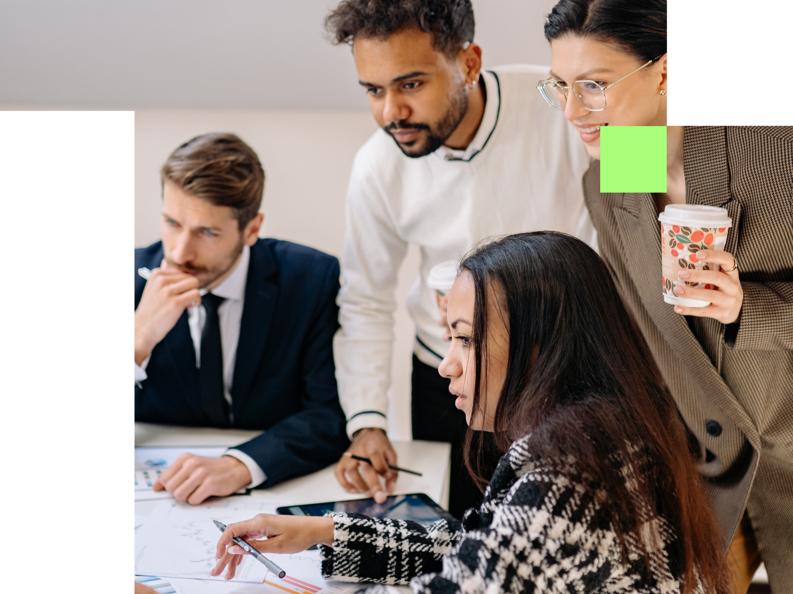 Property professionals collaborating around a laptop, representing Utopi's managed service model where the Impact Team drives outcomes alongside asset managers and operators